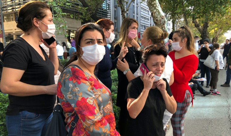 People stand outside their homes in Izmir, Turkey, Friday, Oct. 30, 2020, after a strong earthquake in the Aegean Sea has shaken Turkey and Greece. Turkey's Disaster and Emergency Management Presidency said Friday's earthquake was centered in the Aegean at a depth of 16.5 kilometers (10.3 miles) and registered at a 6.6 magnitude.(AP Photo/Ismail Gokmen)