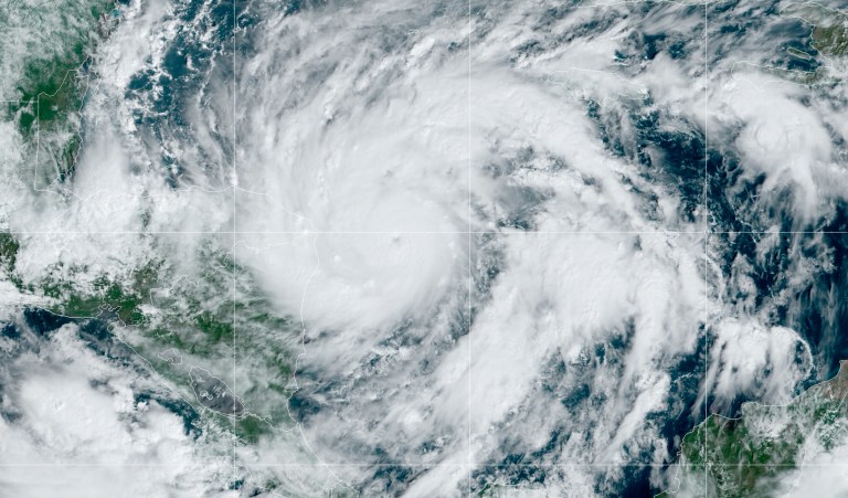 This GeoColor satellite image taken Monday, Nov. 2, 2020, at 1 p.m. EDT, and provided by NOAA, shows Hurricane Eta approaching the border of Honduras and Nicaragua. New Hurricane Eta quickly gained force Monday as it headed for Central America on the verge of becoming a major hurricane, threatening massive flooding and landslides across a vulnerable region. (NOAA via AP)