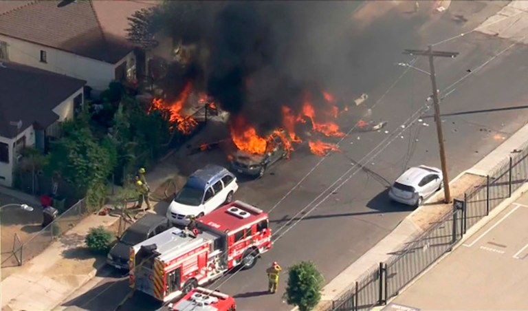 This photo from video provided by KTLA-TV shows a small plane that crashed and burned on a street just outside a small airfield in Los Angelesâ San Fernando Valley Thursday, Nov. 12, 2020. A KTLA news helicopter overhead showed fire burning parked cars in the street and on a lawn of a house in a neighborhood off one end of Whiteman Airportâs single runway in the Pacoima neighborhood about 15 miles northwest of downtown Los Angeles. (KTLA-TV via AP)