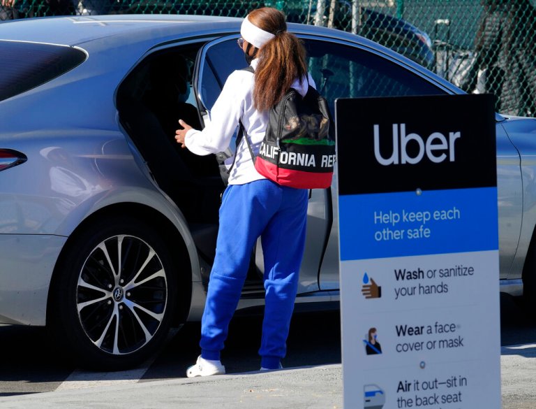 A traveler rides in the back of an Uber vehicle at Los Angeles International Airport in Los Angeles Friday, Nov. 13, 2020. 