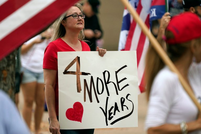 A supporter of President Donald Trump holds a sign during a post-election rally in front of City Hall in Dallas, Saturday, Nov. 14, 2020.
