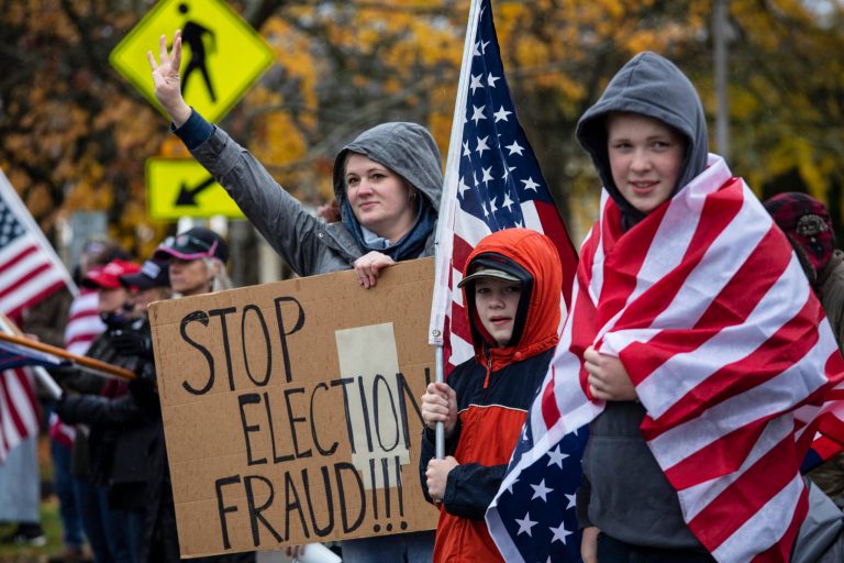 Supporters of President Donald Trump hold signs as they attend a "Stop The Steal" rally, protesting the outcome of the presidential election, at the Oregon State Capitol, Saturday, Nov. 14, 2020, in Salem, Ore.