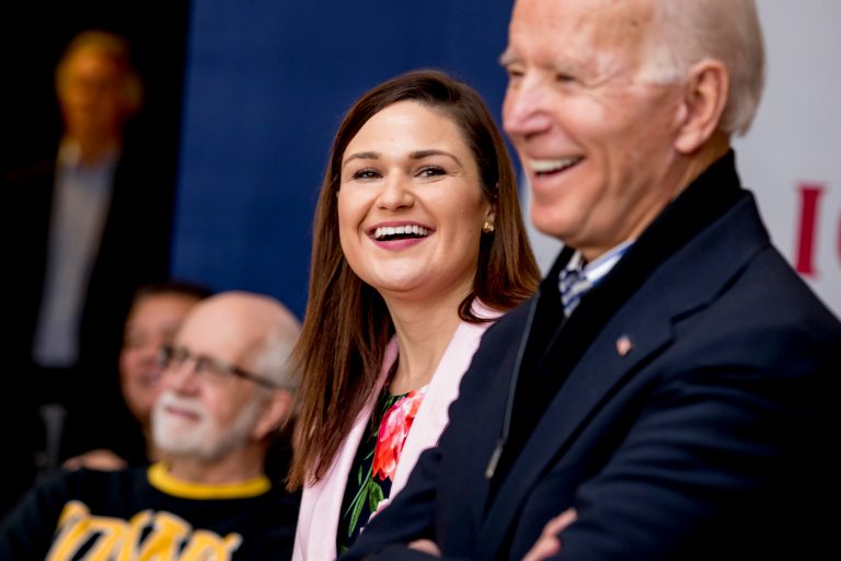 In this Jan. 3 2020, photo, Democratic presidential candidate Joe Biden, right, and Rep. Abby Finkenauer, D-Iowa, center, smile during a campaign rally at the University of Dubuque in Dubuque, Iowa.