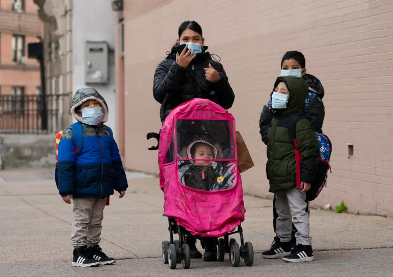 A woman and her children walk to P.S. 134 Henrietta Szold Elementary Schoo on Dec. 7 in New York. 