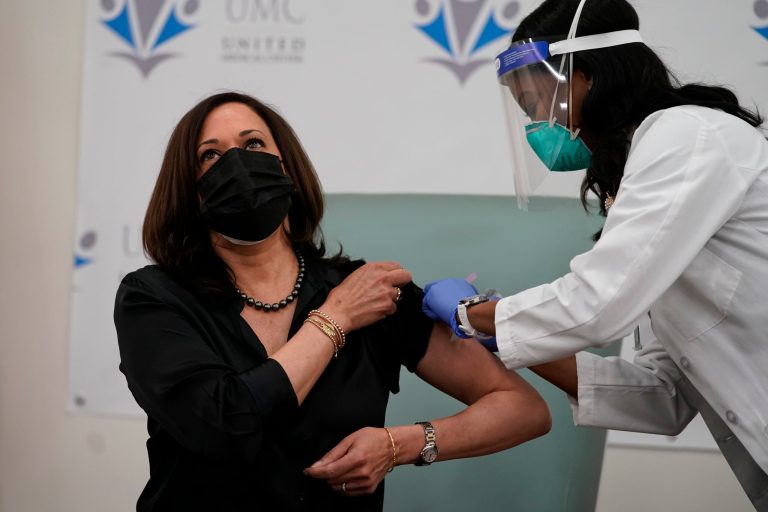 Kiss off: Vaccinated Harris and her husband smooch with masks on