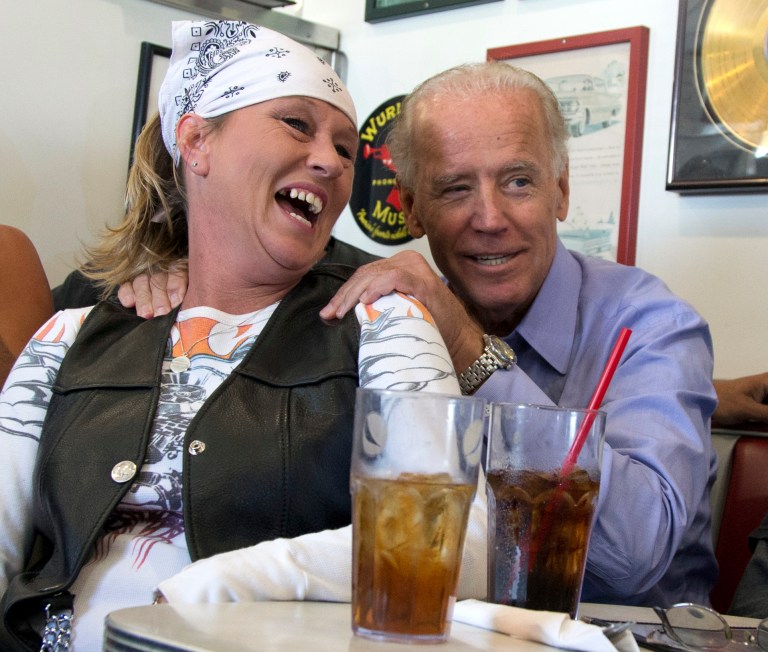 FILE - In this Sept. 9, 2012 file photo, Vice President Joe Biden visits with patrons over lunch at Cruisers Diner in Seaman, Ohio. Biden buddied up with bikers, posed for countless pictures at a pizza place. Obama goes airborne in a doozie of a bear hug with a pizza guy in Florida. Joe Biden cozies up with a biker chick in Ohio. Even the more reserved Mitt Romney seems to be loosening up some with people he meets on the campaign trail. Kissing babies and slapping backs are so yesterday. The 2012 candidates are putting their all into the campaign cliche of pressing the flesh. (AP Photo/Carolyn Kaster, File)