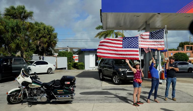  In this Dec. 31, 2020, file photo supporters of President Donald Trump watch as his motorcade passes by in West Palm Beach, Fla. (AP Photo/Patrick Semansky, File)