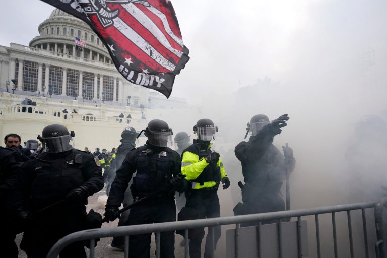 Police hold off Trump supporters who tried to break through a police barrier, Wednesday, Jan. 6, 2021, at the Capitol in Washington.