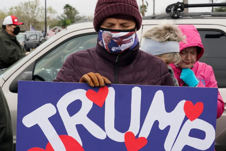 Supporters of Donald Trump pray as they wait in anticipation of his visit to the U.S.-Mexico border, Tuesday, Jan. 12, 2021, in Harlingen, Texas.
