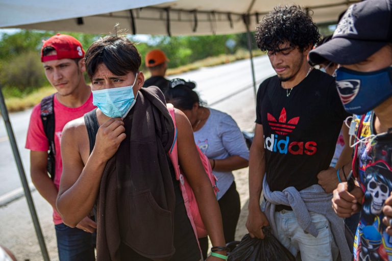 Detained Honduran migrants wait at a police checkpoint to be returned by bus to El Florido, one of the border points between Guatemala and Honduras, near Zacapa, Guatemala, Wednesday. A once large caravan of Honduran migrants that pushed its way into Guatemala last week in hopes of reaching the U.S. dissipated in the face of Guatemalan security forces, while small groups pressed on toward the Mexican border.