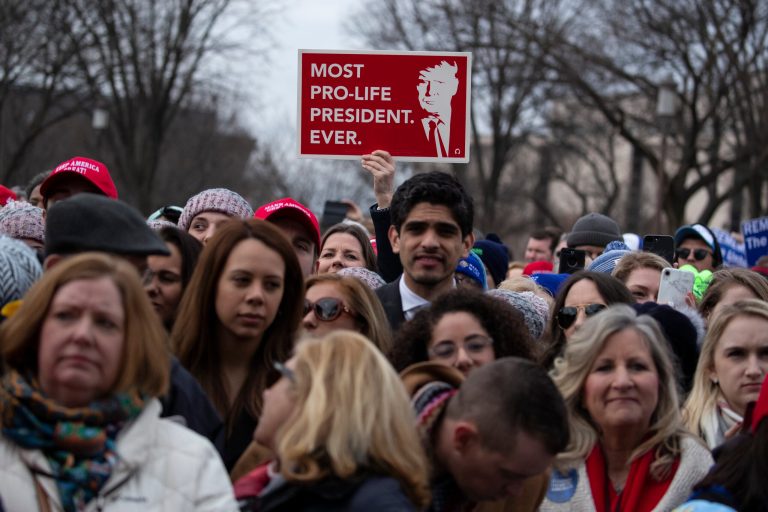 In this Jan. 24, 2020, photo, supporters listen as then-President Donald Trump speaks during the annual 