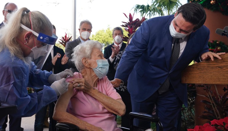 In this Dec. 16, 2020, file photo, Florida Gov. Ron DeSantis asks Vera Leip, 88, how she feels after nurse Christine Philips, left, administered the Pfizer vaccine at John Knox Village, in Pompano Beach, Fla.