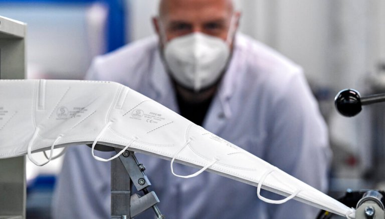 Manager Christian Vorbau of mask producer Sentias controls the production of FFP2 face masks against the spread of the coronavirus in Wuppertal, Germany, on Jan. 28, 2021.