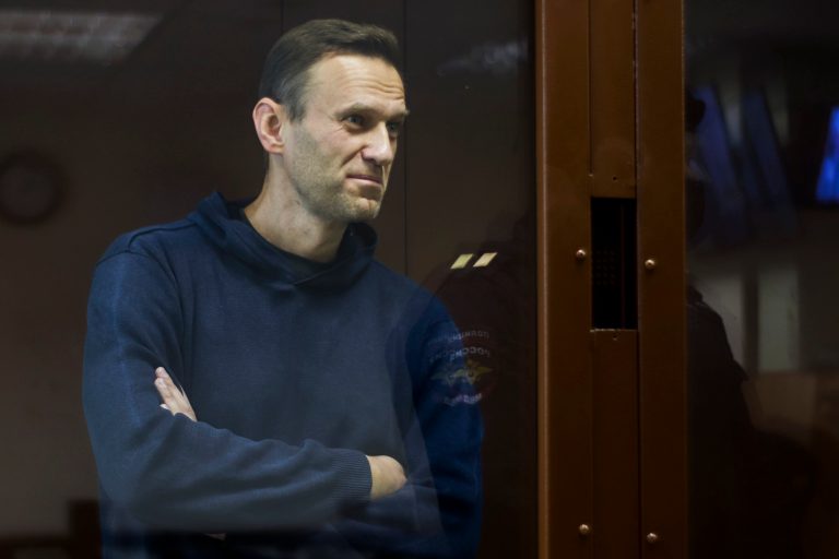 In this photo provided by the Babuskinsky District Court, Russian opposition leader Alexei Navalny stands in a cage during a hearing on his charges for defamation, in the Babuskinsky District Court in Moscow, Russia, Friday, Feb. 5, 2021.