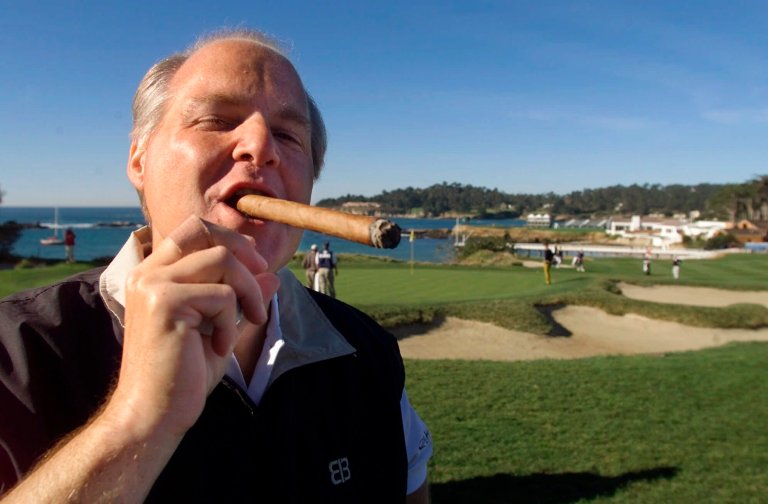 In this Feb. 3, 2001, file photo, Rush Limbaugh puffs on his Ashton VSG cigar while waiting to tee off from the fifth tee of the Pebble Beach Golf Links during third round play of the AT&T Pebble Beach National Pro-Am in Pebble Beach, Calif. Limbaugh, the talk radio host who became the voice of American conservatism, died Wednesday at 70.