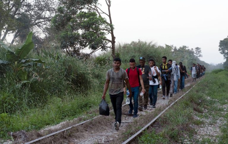 Migrants walk on train tracks on their journey from Central America to the U.S. border, in Palenque, Chiapas state, Mexico, Wednesday, Feb. 10, 2021. President Joe Biden's administration has taken steps toward rolling back Trump policies.
