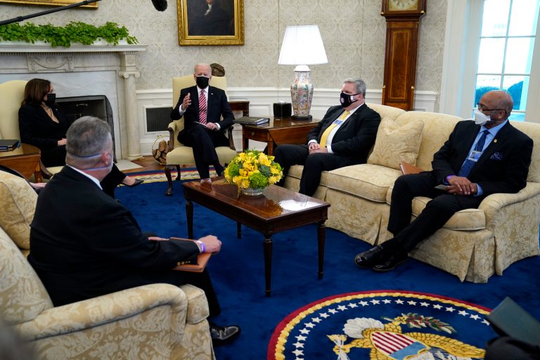 President Joe Biden and Vice President Kamala Harris meet with labor leaders in the Oval Office of the White House, Wednesday, Feb. 17, 2021, in Washington. Eric Dean, general president of the Ironworkers International Union, second from right, and Kenneth Rigmaiden, general president of the International Union of Painters and Allied Trades, right, listen. AFL-CIO chief Richard Trumka was also there.