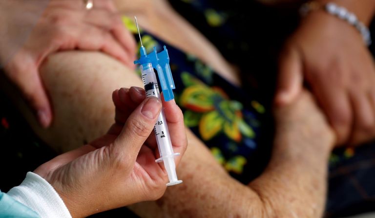 A healthcare worker applies the second dose of China's Sinovac CoronaVac vaccine during a priority vaccination program for the elderly at Bezerra de Menezes Asylum in Brasilia, Brazil, Thursday, Feb. 18, 2021.