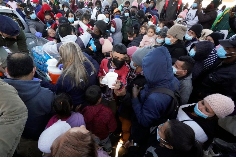 Asylum seekers receive food as they wait for news at the border, Friday in Tijuana, Mexico. After waiting in Mexico, people seeking asylum in the United States were being allowed into the country last week as they wait for courts to decide on their cases.