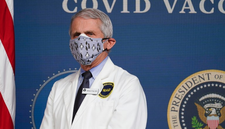 Dr. Anthony Fauci, director of the National Institute of Allergy and Infectious Diseases, listens as President Joe Biden speaks during an event to commemorate the 50 millionth COVID-19 shot, in the South Court Auditorium on the White House campus, Thursday, Feb. 25, 2021, in Washington.