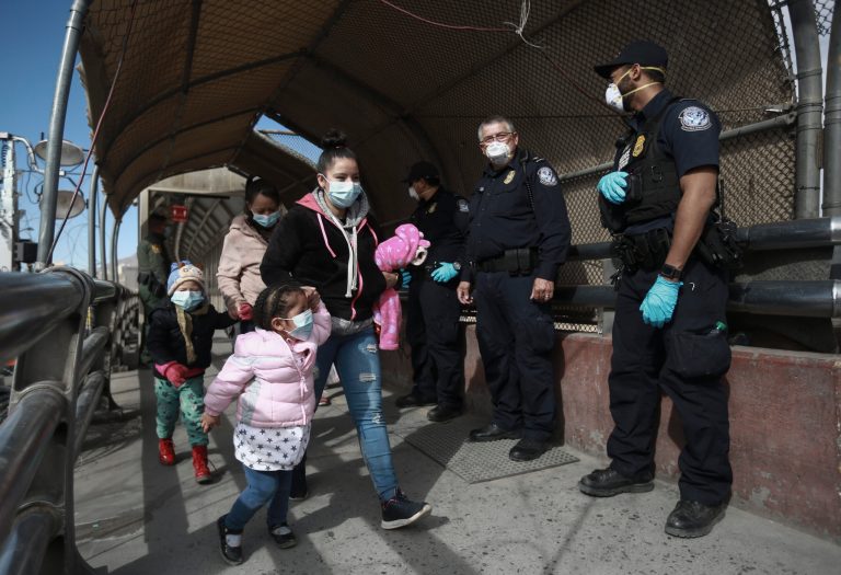 A migrant family crosses the border into El Paso, Texas, Friday, Feb. 26, 2021