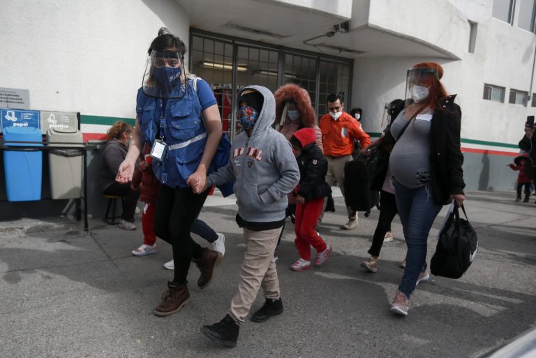 A migrant family crosses the border into El Paso, Texas, in Ciudad Juarez, Mexico, Friday, Feb. 26, 2021. After waiting months and sometimes years in Mexico, people seeking asylum in the United States are being allowed into the country as they wait for courts to decide on their cases, unwinding one of the Trump administration's signature immigration policies that President Joe Biden vowed to end.