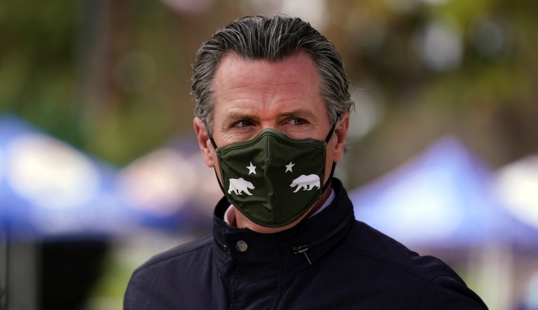 California Gov. Gavin Newsom wears a mask during a visit to a vaccination center Wednesday, March 10, 2021, in South Gate, Calif.