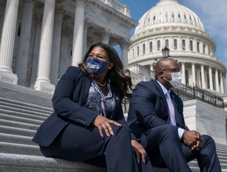 Rep. Cori Bush, D-Mo., left, and Rep. Jamaal Bowman, D-N.Y., enjoy the warm weather before a vote in the House.