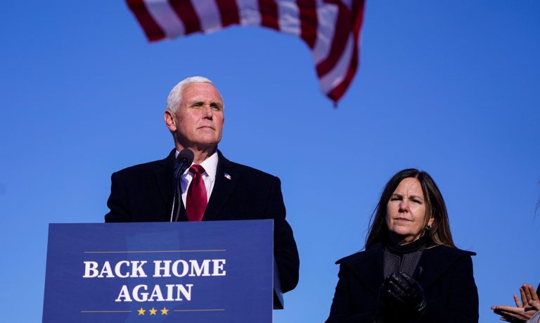 In this file picture, former Vice President Mike Pence speaks after arriving back in his hometown of Columbus, Ind., as his wife Karen watches. Pence is steadily re-entering public life as he eyes a potential run for the White House in 2024. He's writing op-eds, delivering speeches, preparing trips to early voting states and launching an advocacy group likely to focus on promoting the accomplishments of the Trump administration.