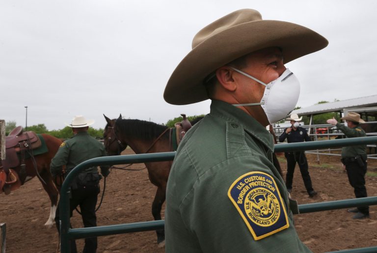 Twenty migrants, including two children, found crammed underneath flatbed truck trailer