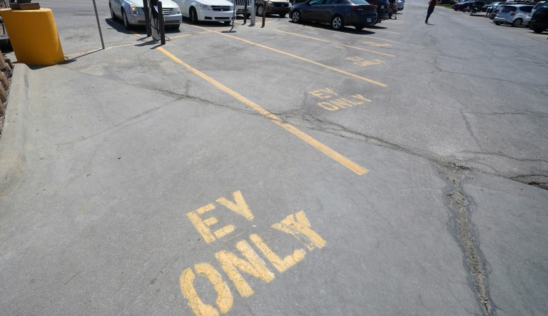 Four electric vehicle charging spots stand empty in a grocery story parking lot in Lawrence, Kan., Monday, April 5, 2021. The president and the auto industry maintain the nation is on the cusp of a gigantic shift to electric vehicles and away from liquid-fueled cars, but biofuels producers and some of their supporters in Congress arenât buying it. They argue the U.S. should increase sales of ethanol and biodiesel, not abandon them.