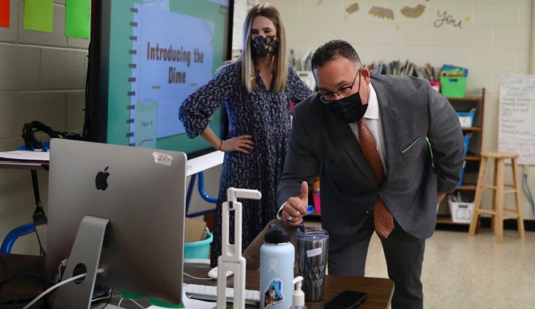 U.S. Secretary of Education Miguel Cardona, right, talks to students learning online while visiting teacher Meghan Horleman's second grade classroom at the Olney Elementary School Annex in North Philadelphia on Tuesday, April 6, 2021.
