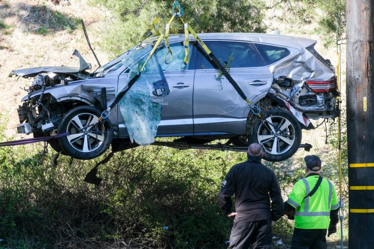 FILE - In this Feb. 23, 2021, file photo, a crane is used to lift a vehicle following a rollover accident involving golfer Tiger Woods, in the Rancho Palos Verdes suburb of Los Angeles. (AP Photo/Ringo H.W. Chiu, File)