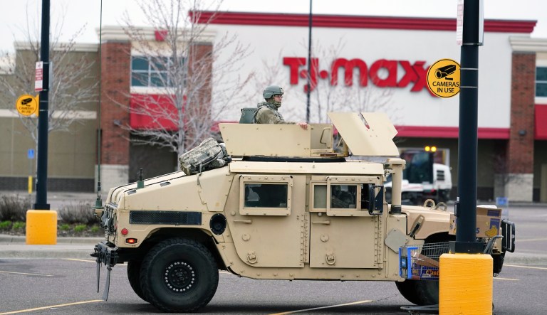 A National Guard soldier maintains watch in a shopping center parking area on Monday, April 12, 2021, following a night of unrest and looting in Brooklyn Center, Minn, a Minneapolis suburb, following the shooting death by police of a Black man after a traffic stop Sunday.