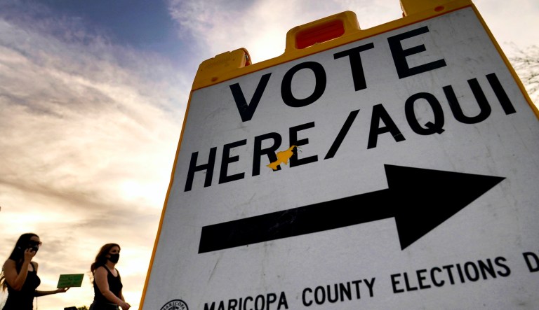 In this Nov. 3, 2020, file photo voters deliver their ballot to a polling station in Tempe, Ariz.