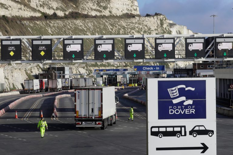 FILE - In this Friday, Dec. 25, 2020 file photo, trucks line up at check-in to the ferry at The Port of Dover, Kent, England.  (AP Photo/Kirsty Wigglesworth, file)