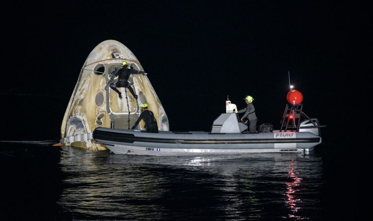 Support teams work around the SpaceX Crew Dragon Resilience spacecraft shortly after it landed. (Bill Ingalls/NASA via AP)