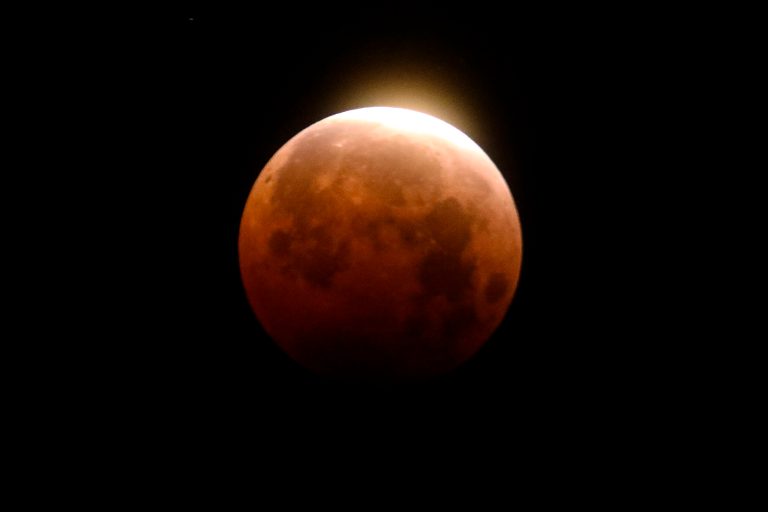 Light shines from a total lunar eclipse over Santa Monica Beach in Santa Monica, Calif., Wednesday, May 26, 2021. AP Photo/Ringo H.W. Chiu)