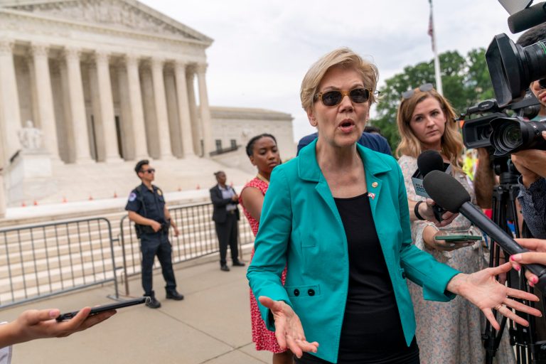 Sen. Elizabeth Warren, D-Mass., speaks to members of the media after speaking at a rally in front of the Supreme Court in Washington, Wednesday, June 9, 2021.