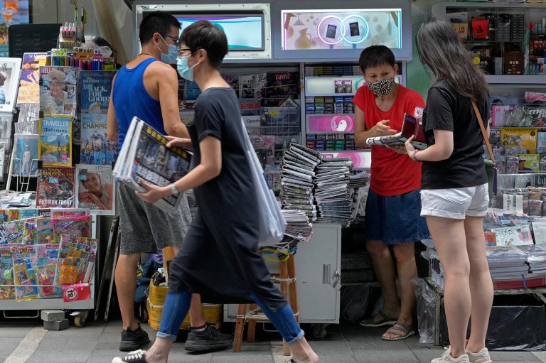 Hong Kong newspaper prints over 400,000 more copies after editors are arrested