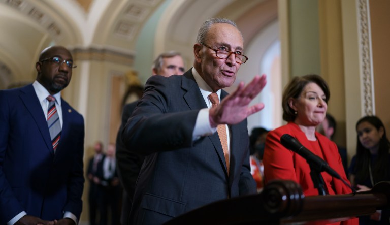 Senate Majority Leader Chuck Schumer, D-N.Y., flanked by Sen. Raphael Warnock, D-Ga., left, and Sen. Amy Klobuchar, D-Minn., speaks with reporters before a key test vote on the For the People Act, a sweeping bill that would overhaul the election system and voting rights, at the Capitol in Washington, Tuesday, June 22, 2021.