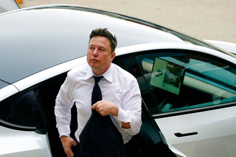 Elon Musk arrives at the justice center in Wilmington, Del., Tuesday, July 13, 2021. Musk took to a witness stand Monday to defend his company's 2016 acquisition of a troubled company called SolarCity against a shareholder lawsuit that claims he's to blame for a deal that was rife with conflicts of interest and never delivered the profits he had promised.