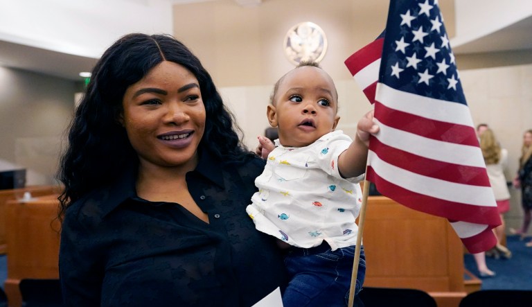 Loyal Pyron, nine months, waves his mother, Londiwe S Masango Pyronâs new American flag during her naturalization ceremony at the United States Courthouse in Jackson, Miss., Tuesday, July 13, 2021. Loyal, who was born in the United States, was already an American citizen by virtue of being born in the country.