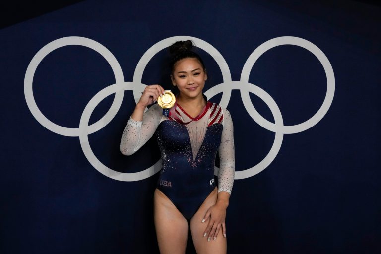 Sunisa Lee, of United States, reacts as she poses for a picture after winning the gold medal in the artistic gymnastics women's all-around final at the 2020 Summer Olympics, Thursday, July 29, 2021, in Tokyo, Japan. (AP Photo/Gregory Bull)