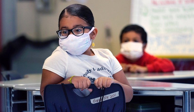  A a summer school student wears a protective mask while listening to instruction, at the E.N. White School in Holyoke, Mass., on Wednesday, Aug. 4, 2021. Schools across the U.S. are about to start a new year amid a flood of federal money larger than they've ever seen before, an infusion of pandemic relief aid that is four times the amount the U.S. Department of Education sends to K-12 schools in a typical year.