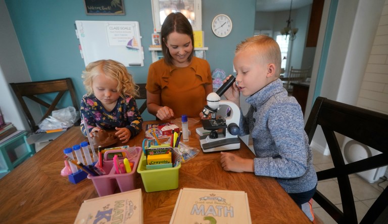 Stefanie Plothow home schools her children Cameron, 9, in the 3rd grade, and Ainsley, 5, in kindergarten, Friday, Aug. 20, 2021, in Lehi, Utah. A group of Utah parents is suing the state over a law that bans school districts from approving mask mandates. It's the latest U.S. legal challenge over rules for face coverings in the classroom.