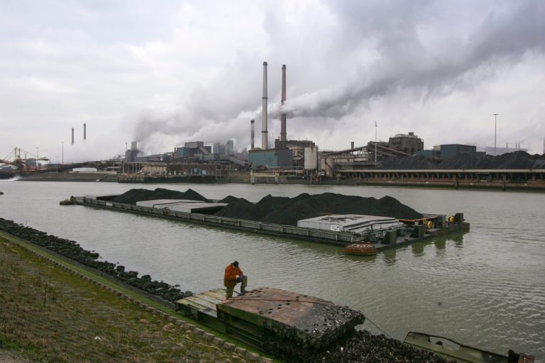 FILE- In this Tuesday Jan. 30, 2007, file photo, a worker is seen on a pontoon near the former Corus, and current Tata steel factory, background, in IJmuiden, Netherlands. The future of steel production at the sprawling Tata plant west of Amsterdam was called into question Thursday Sept. 2, 2021, after an investigation found elevated levels of lead and other deposits in dust falling in nearby residential areas.
