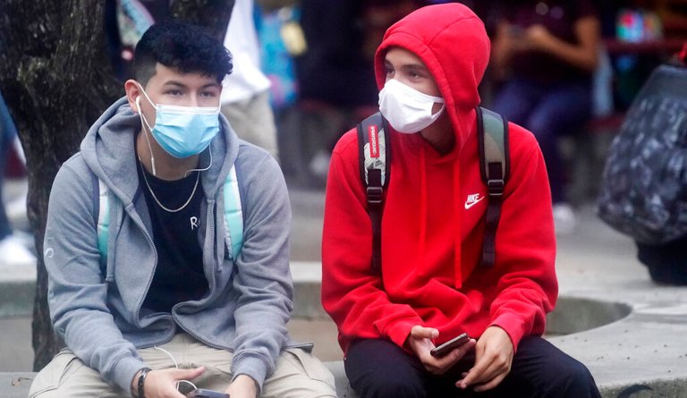 Students wait in a courtyard for classes to start at Barbara Goleman Senior High School, Monday, Aug. 23, 2021, in Miami Lakes, Fla. Public chools in Miami-Dade County have a strict mask mandate to guard against coronavirus infections. A Florida judge ruled Wednesday that the state cannot enforce a ban on public schools mandating the use of masks to guard against the coronavirus, while an appeals court sorts out whether the ban is ultimately legal.