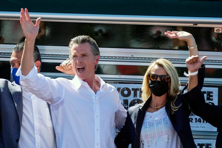 California Gov. Gavin Newsom, left, and his wife Jennifer Siebel wave to supporters at a rally against the California gubernatorial recall election on Sunday, Sept. 12, 2021, in Sun Valley, Calif. (AP Photo/Ringo H.W. Chiu)