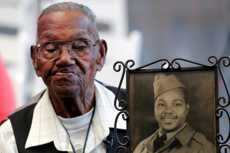 World War II veteran Lawrence Brooks holds a photo of him taken in 1943. 